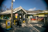 Sun-drenched café corner featuring rustic wooden tables and fresh pastries.