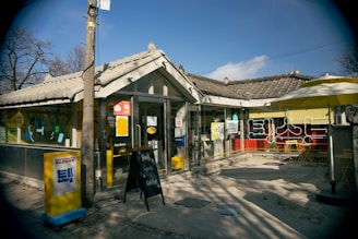 A welcoming café terrace filled with people enjoying coffee and pastries under sunny skies.