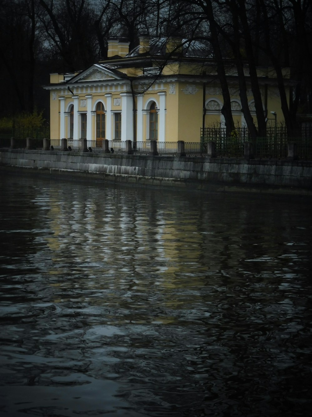 a building sitting next to a body of water