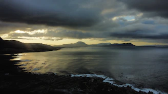 A serene view of the southern Chilean coast with cold winds sweeping over the rugged landscape at dusk.