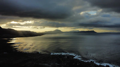 A serene view of the southern Chilean coast with cold winds sweeping over the rugged landscape at dusk.