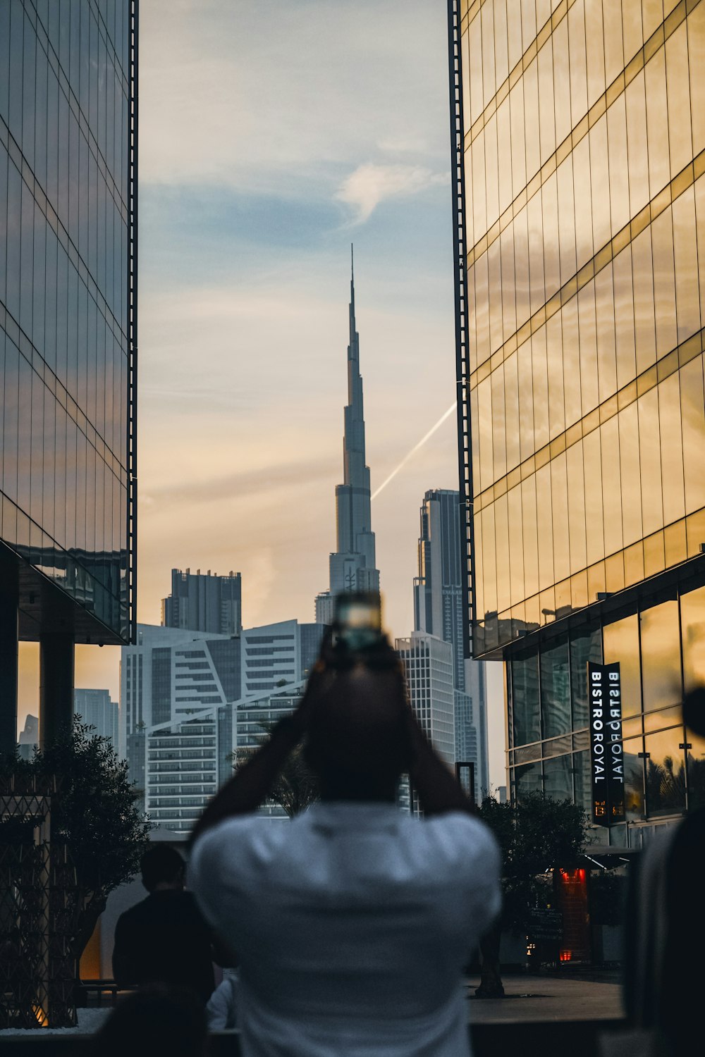 a person taking a picture of a tall building