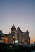Modern municipal building with golden accents illuminated at dusk.