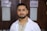 a man in a lab coat standing in front of a door