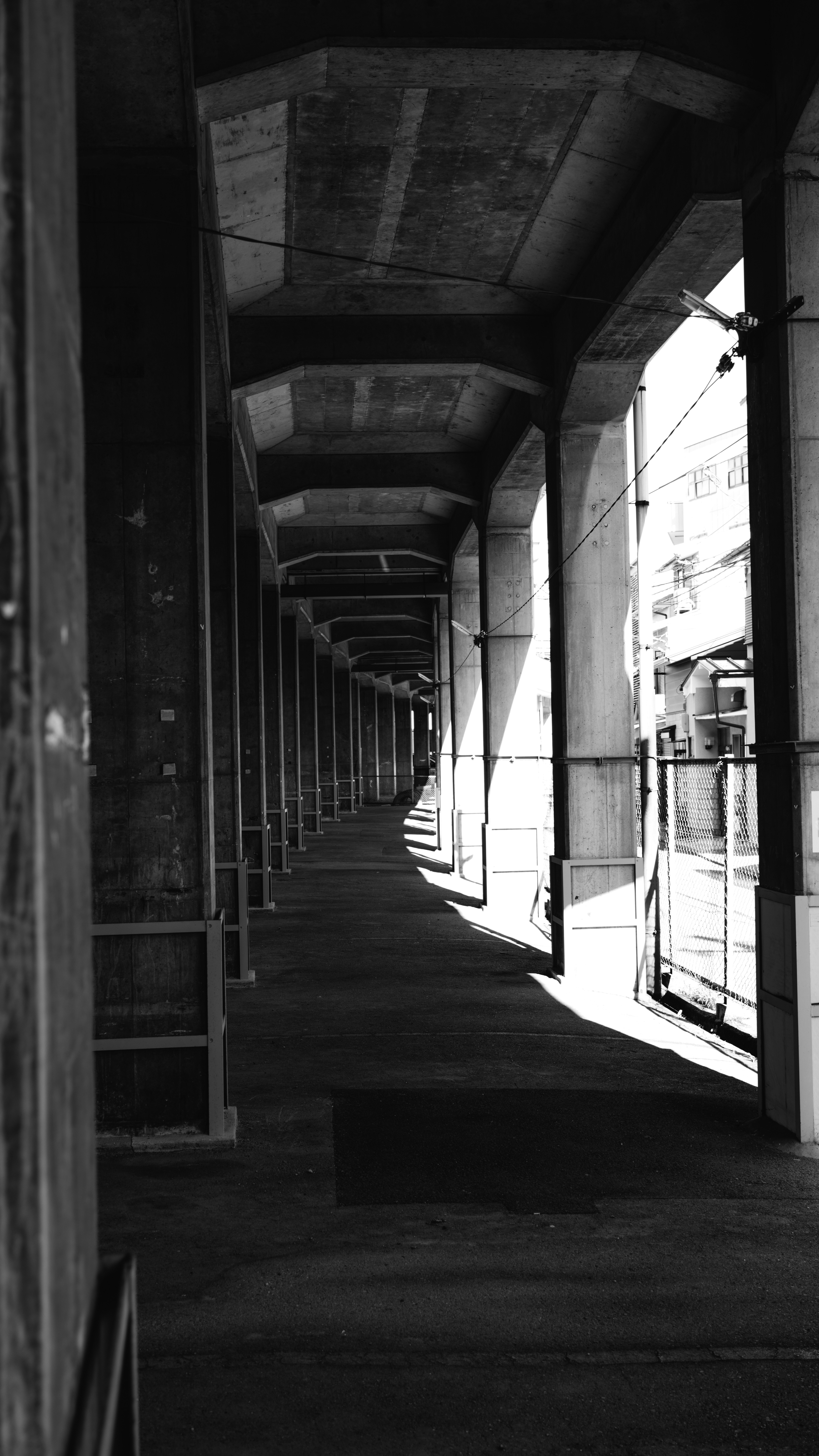 a black and white photo of a long hallway