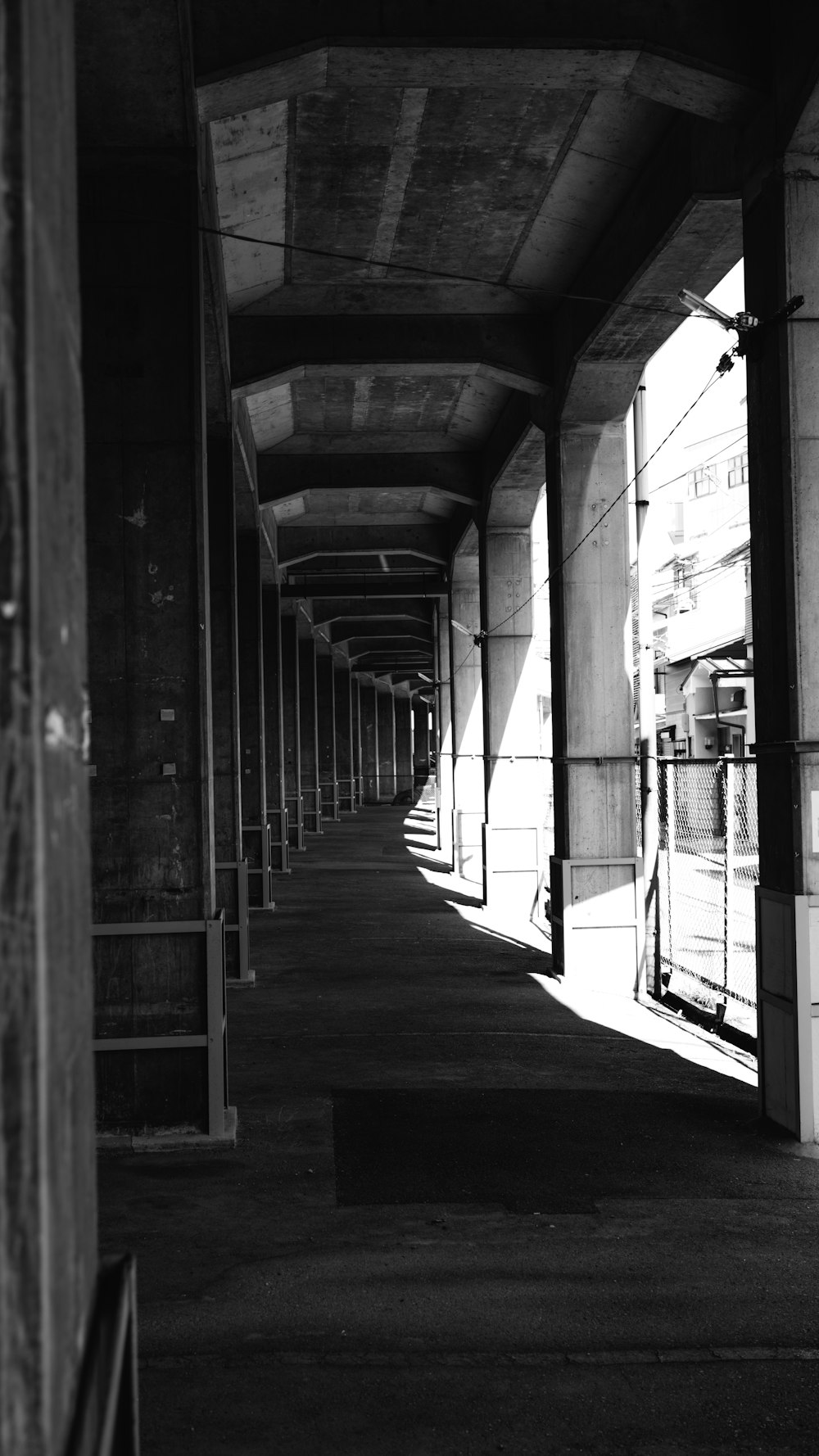 a black and white photo of a long hallway