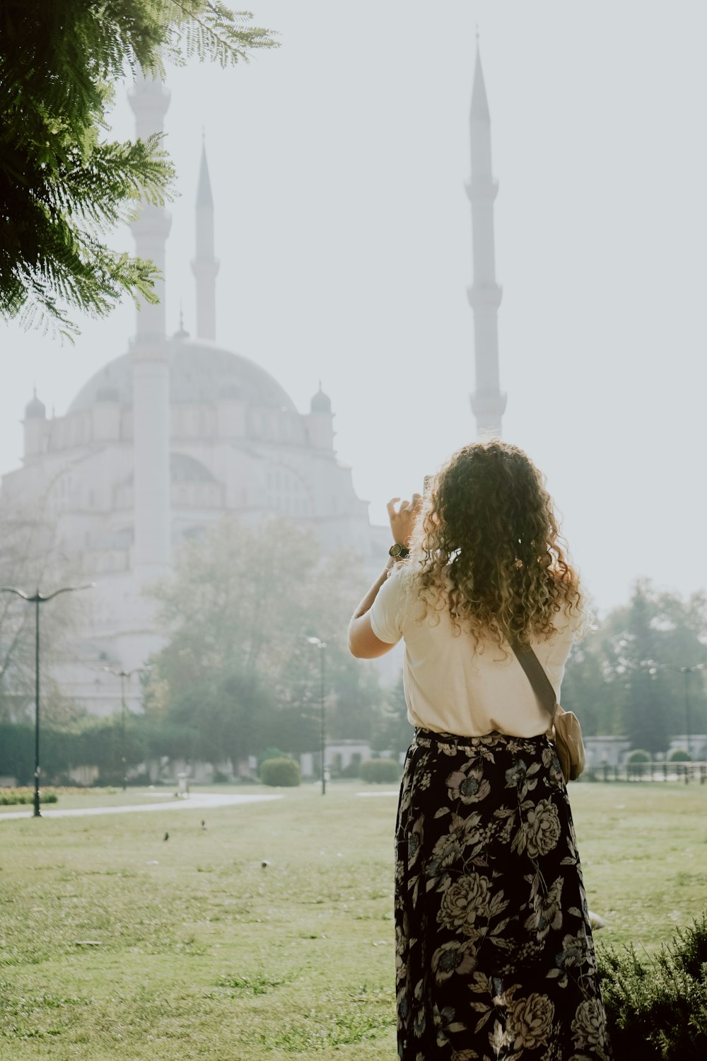 a woman standing in front of a large building