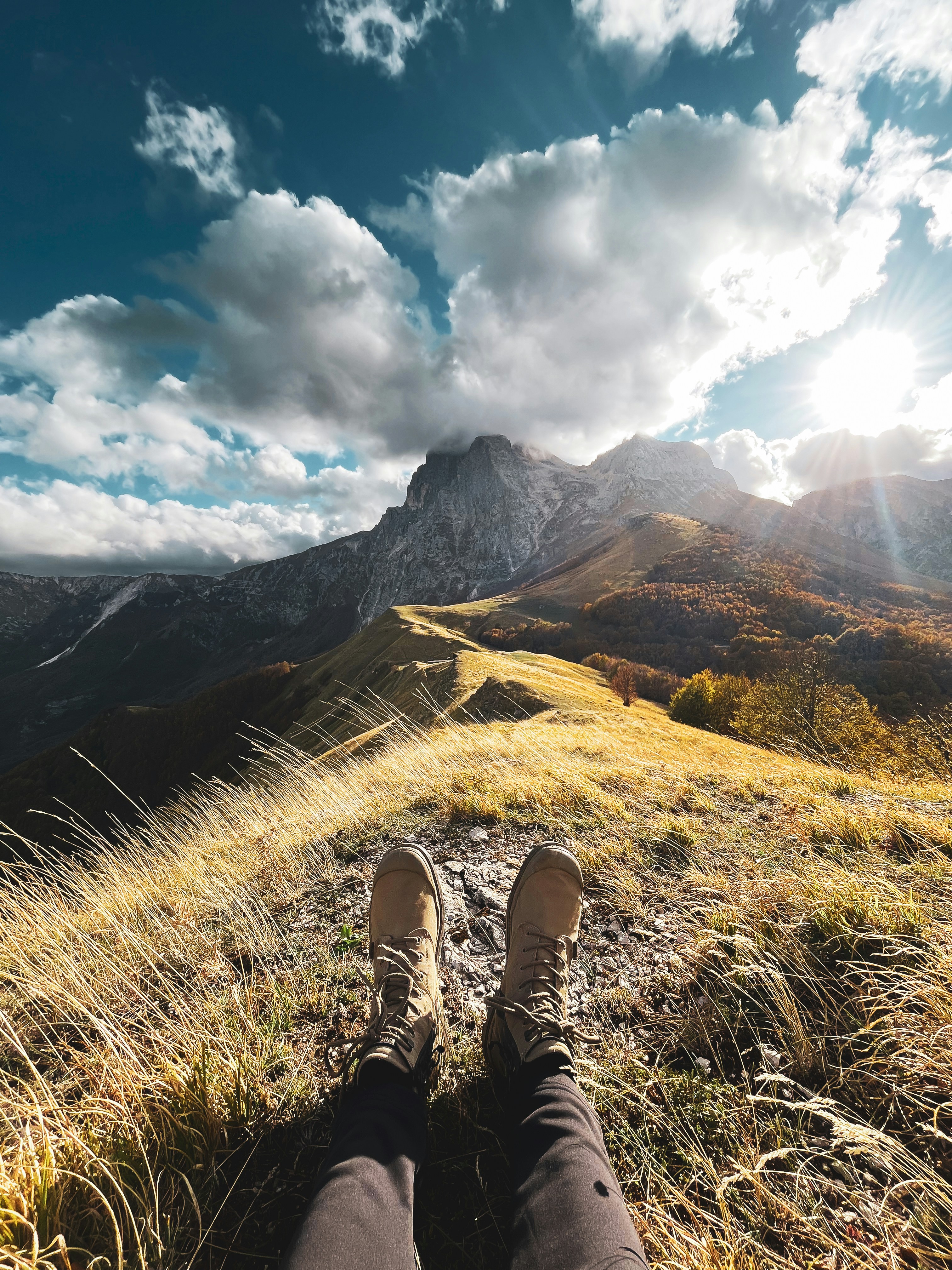 a person with their feet up on a hill