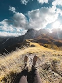 A scenic outdoor shot featuring boots on a rocky path.