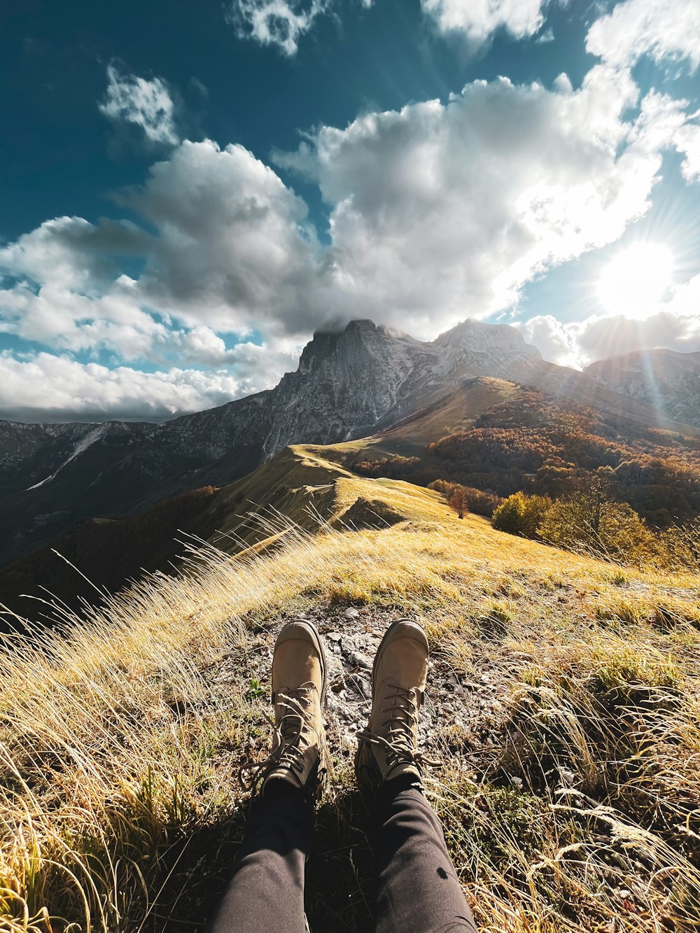 a person with their feet up on a hill