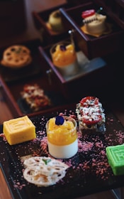 A selection of colorful cakes and desserts on a table.