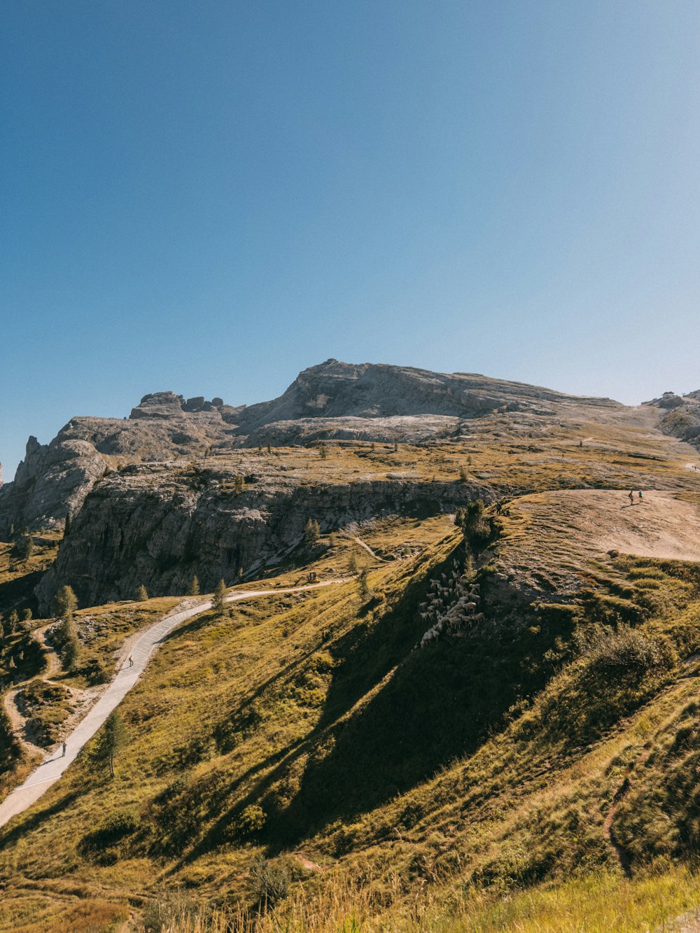 a dirt road going through a valley with mountains in the background