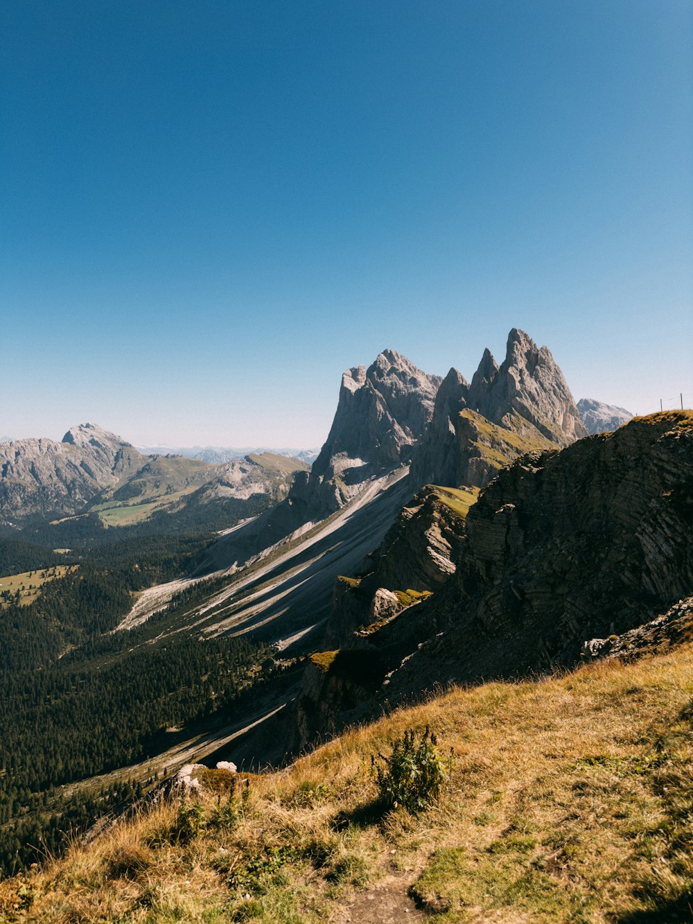 a view of a mountain range from the top of a hill