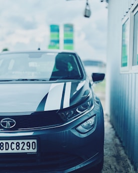 A close-up of a license plate reader camera mounted on a streetlight, capturing passing vehicles under a gray sky.