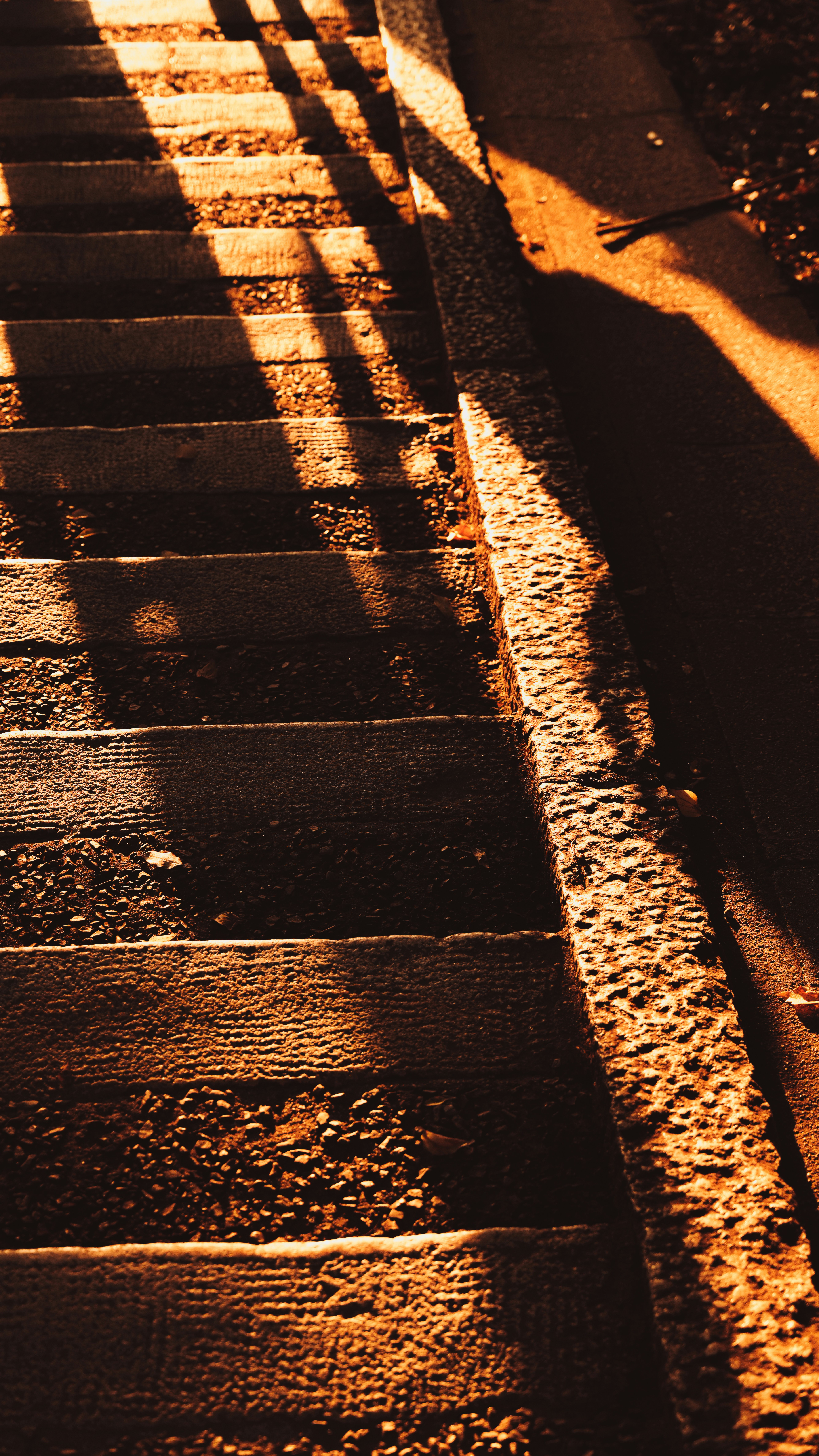 the shadow of a person walking down a set of steps