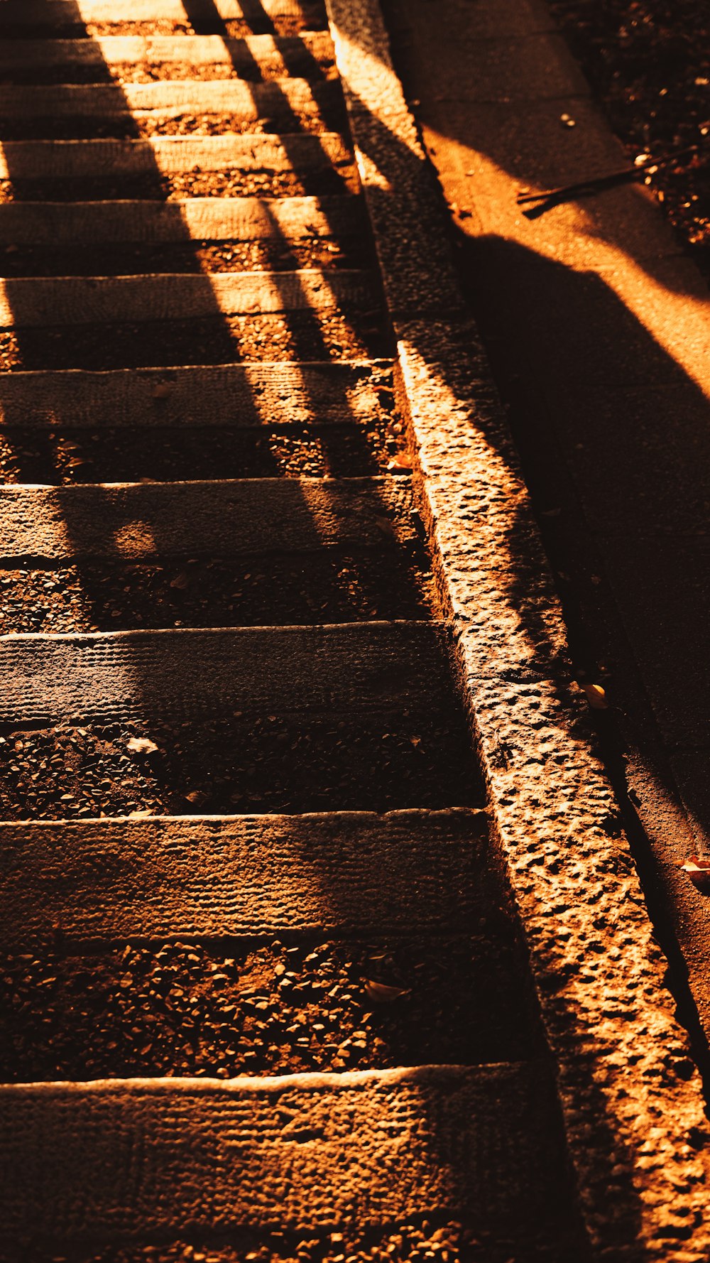 the shadow of a person walking down a set of steps