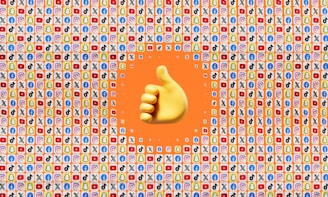 A large yellow thumbs-up emoji is centered against a background filled with small app icons, including popular social media platforms like Facebook, Twitter, Snapchat, TikTok, YouTube, and Instagram. The surrounding area has a predominantly orange color.
