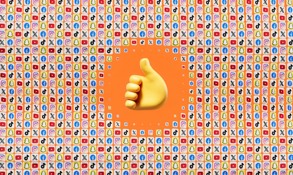 a thumbs up in front of a colorful background