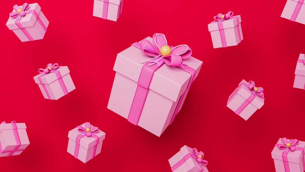 a pink gift box with a pink bow on a red background
