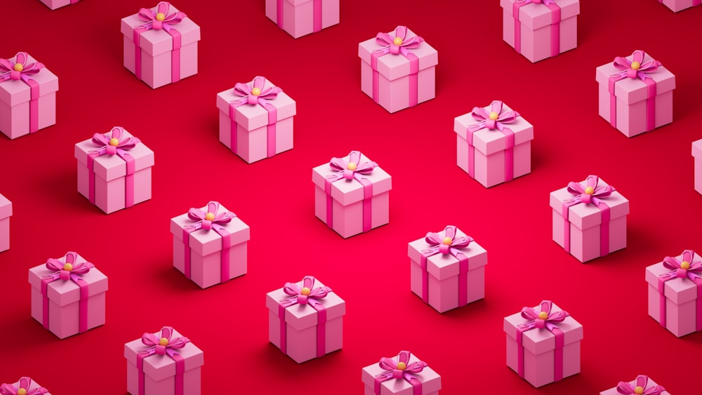 a group of pink wrapped presents on a red background