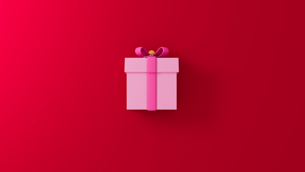 a pink gift box on a red background