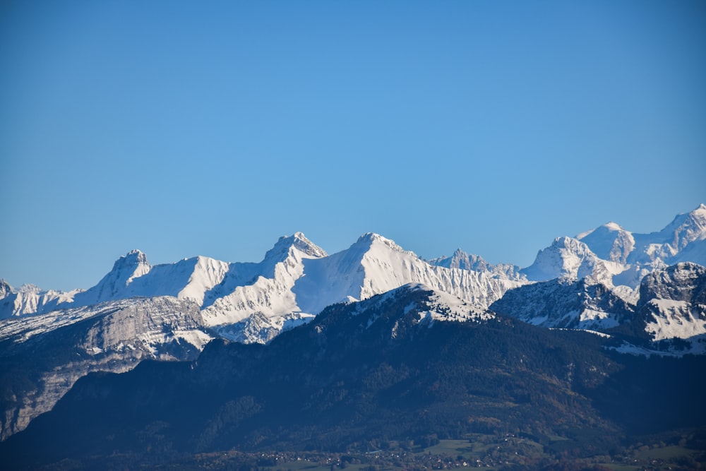 a mountain range with snow capped mountains in the background