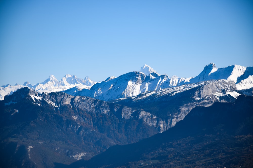 a mountain range with snow covered mountains in the background