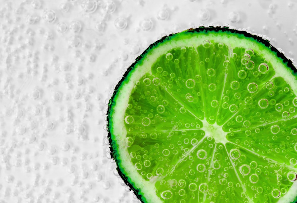 a slice of lime with water droplets on it