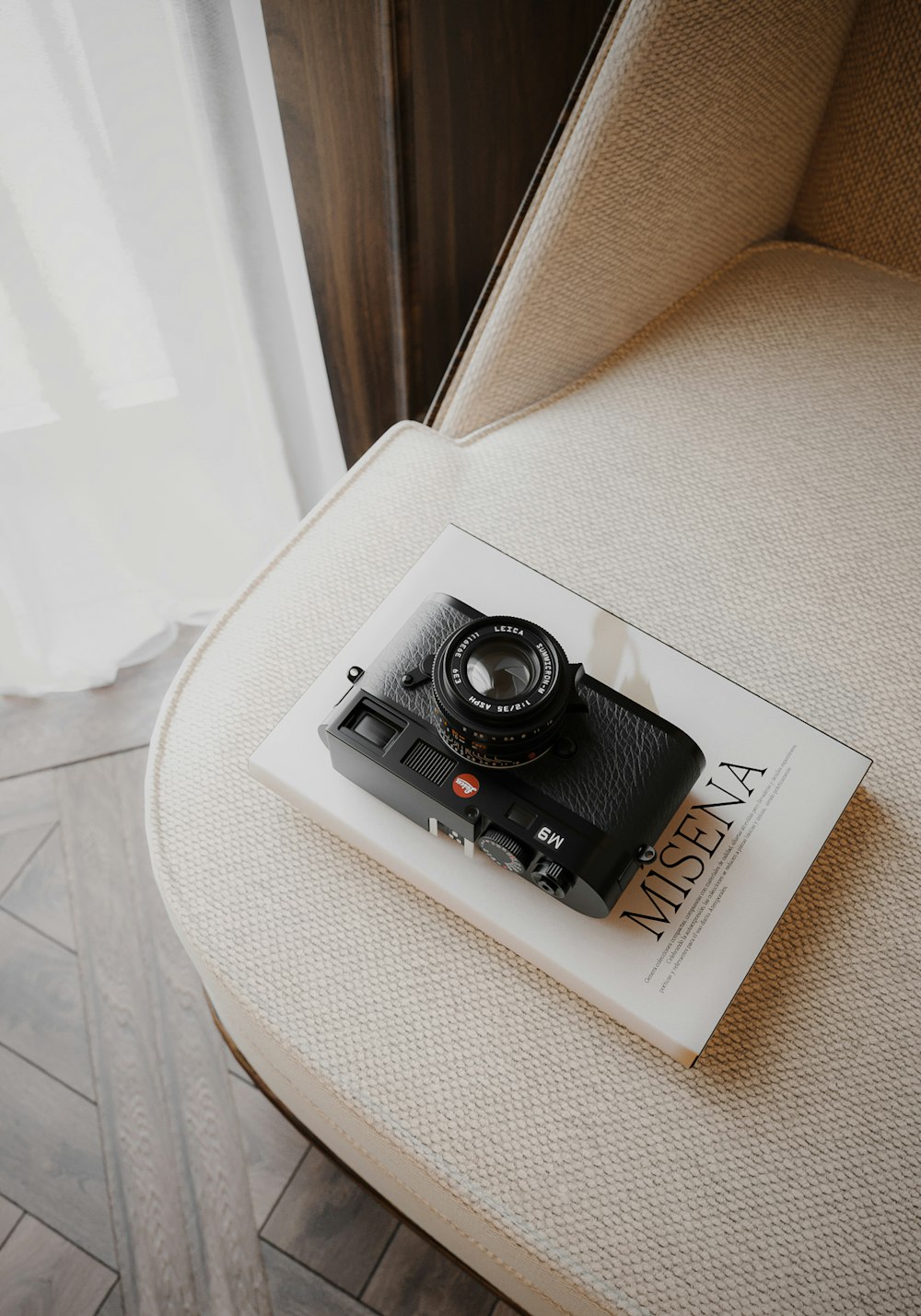 a camera sitting on top of a book on a chair