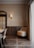 A cozy living room featuring a stylish wall lamp illuminating a comfortable seating area.