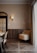 A cozy living room featuring a stylish wall lamp illuminating a comfortable seating area.