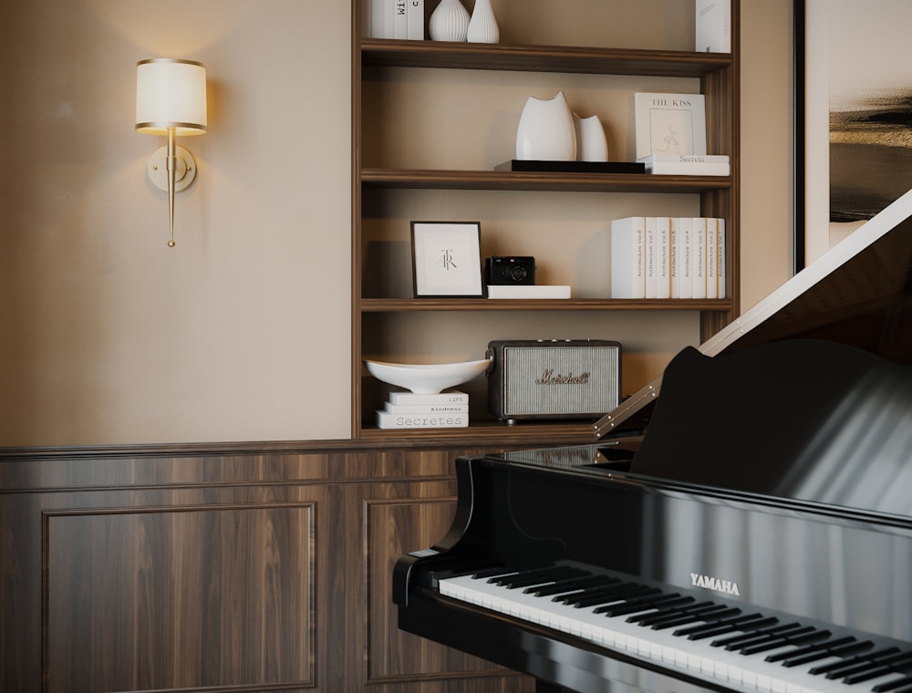 a black piano in a room with shelves