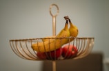 A close-up of fresh organic fruits in a woven basket.
