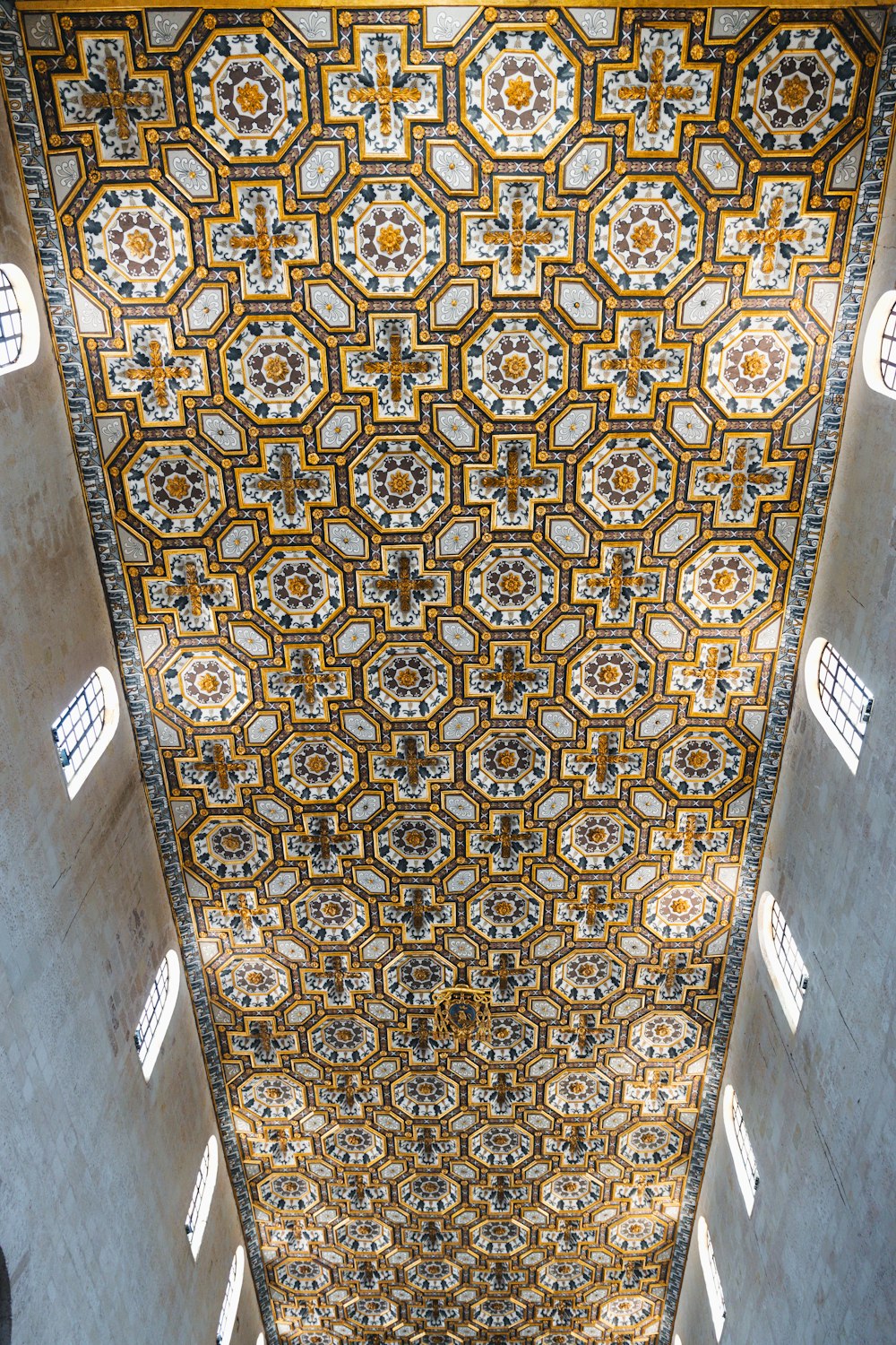 the ceiling of a building with many windows