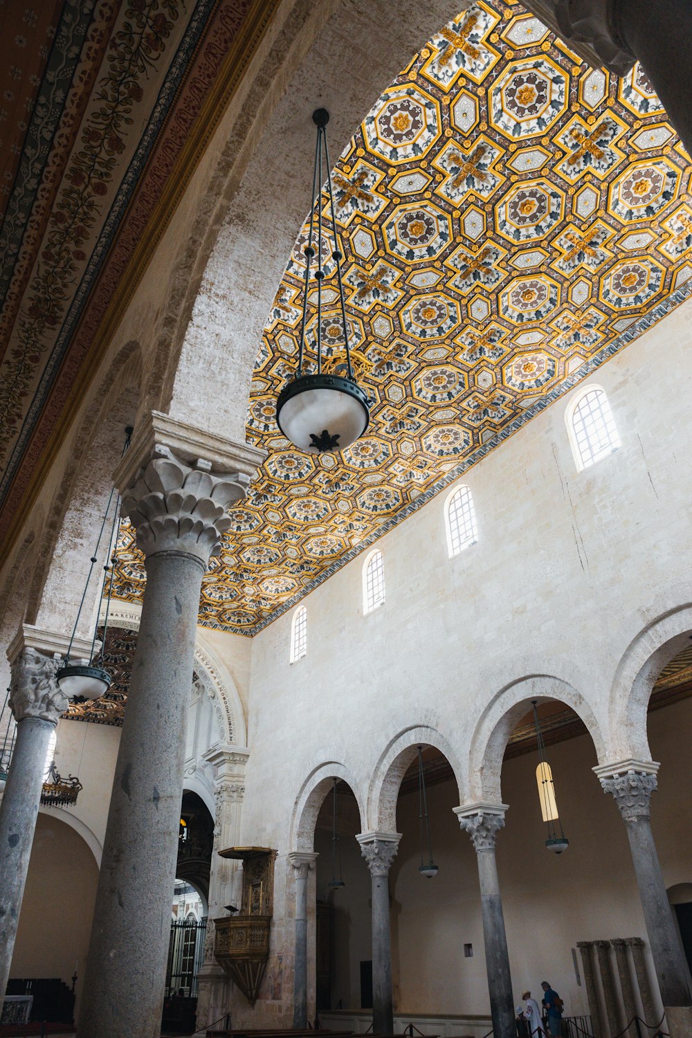 the ceiling of a large building with a chandelier hanging from it's