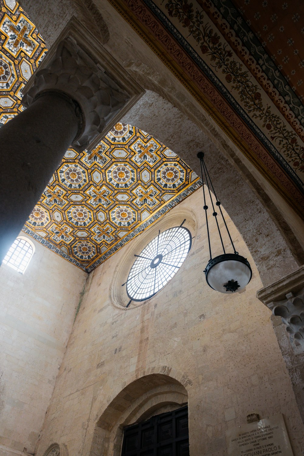 a clock hanging from the ceiling of a building