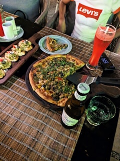 A cozy restaurant setting with a table set for a pizza feast.