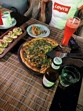A cozy restaurant setting with a table set for a pizza feast.
