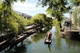 a person in a small boat on a river