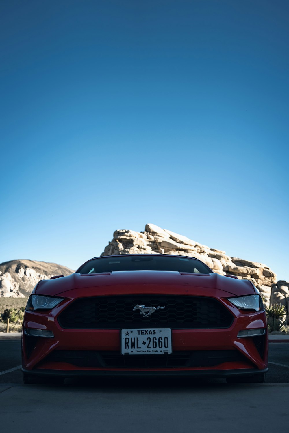 Un Mustang rojo estacionado en un estacionamiento