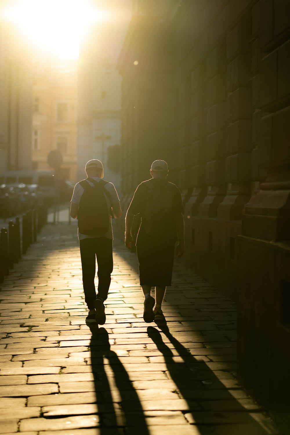 a couple of people walking down a street