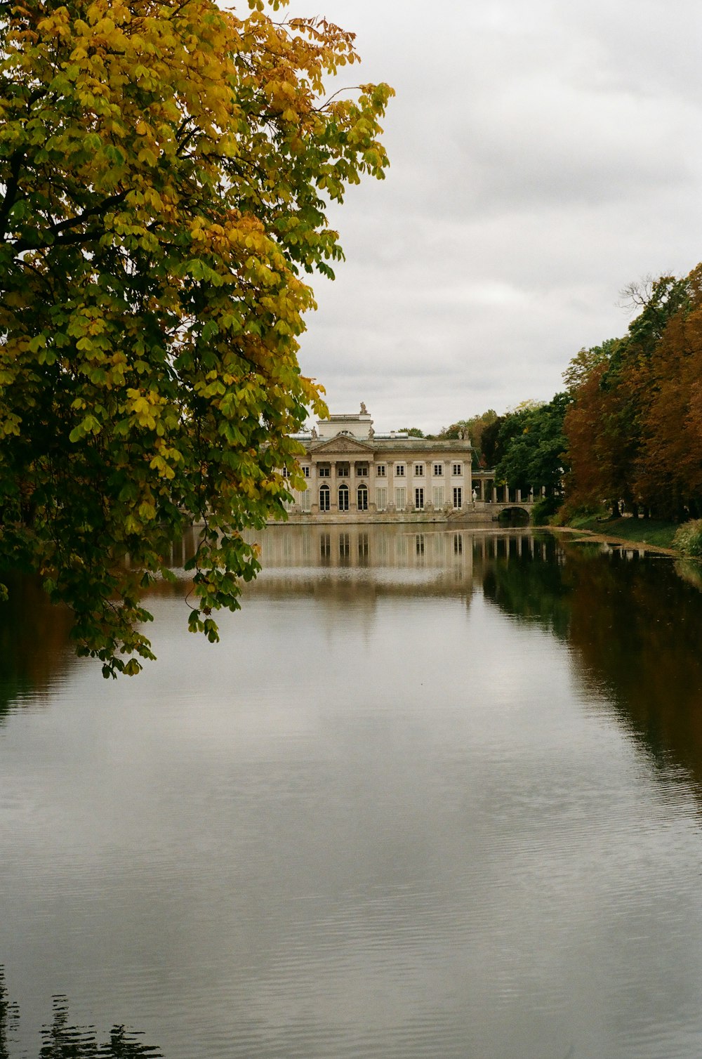 a large white building sitting next to a body of water