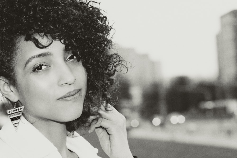 a black and white photo of a woman with curly hair