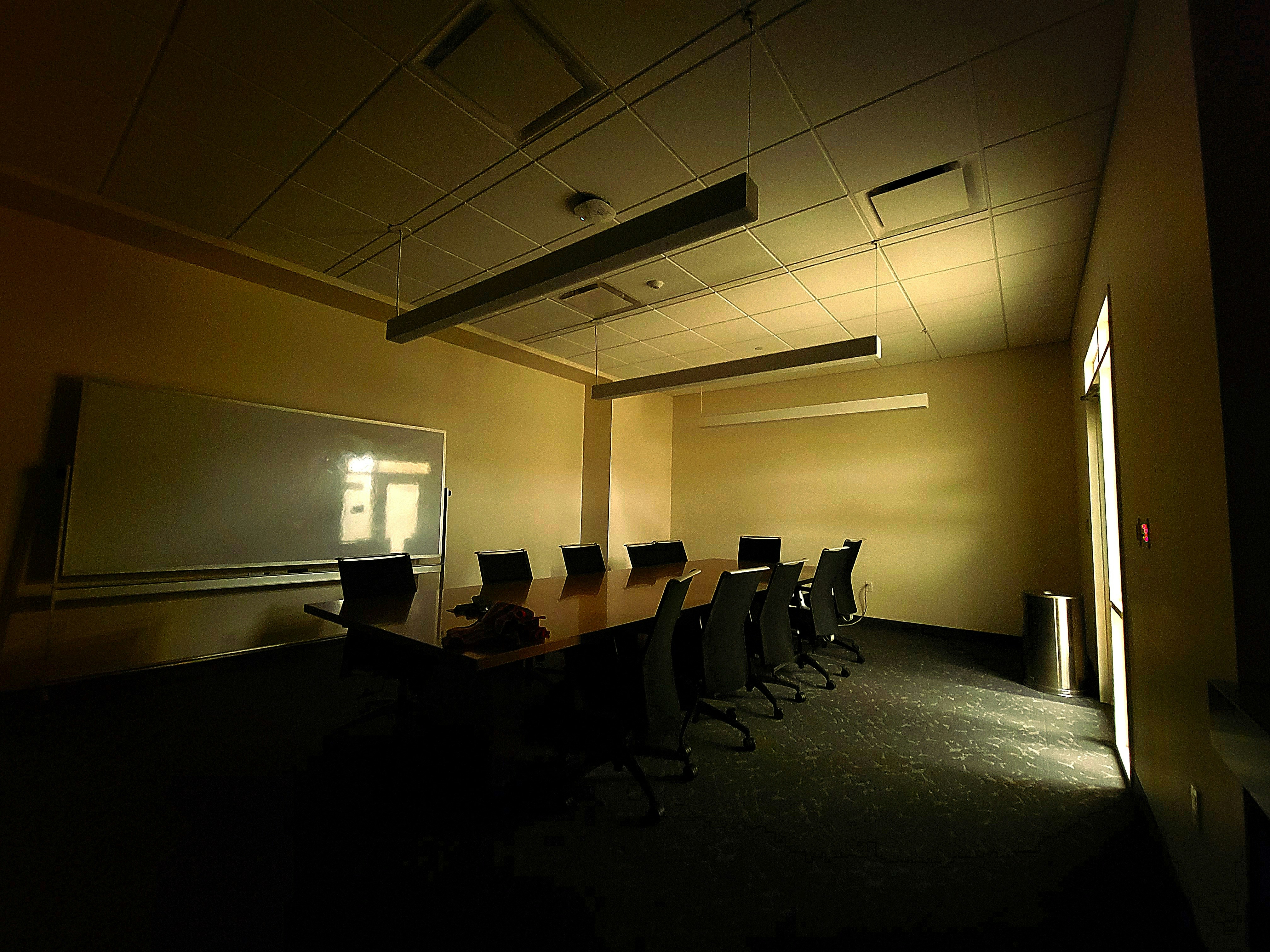 Editorial board members reviewing research papers in a bright conference room.