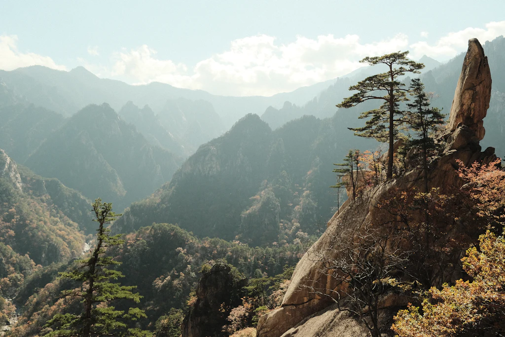 Granite pinnacles and forested valleys in Seoraksan National Park under pale autumn haze