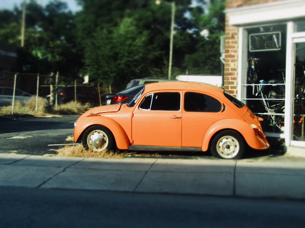 an orange car parked in front of a building