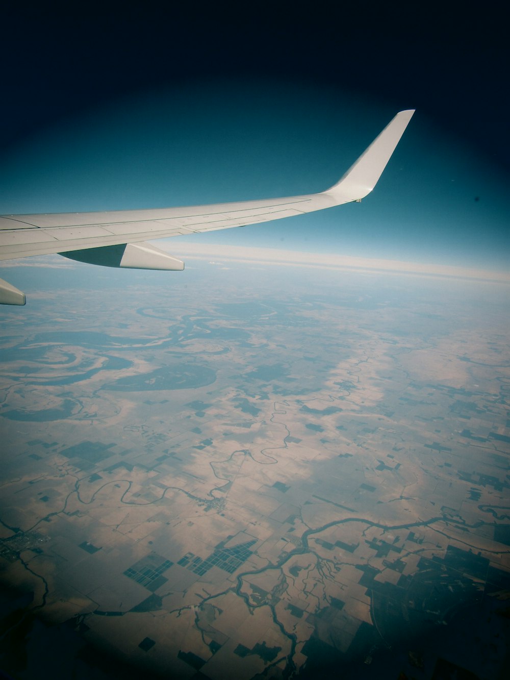 a view of the wing of an airplane in the sky