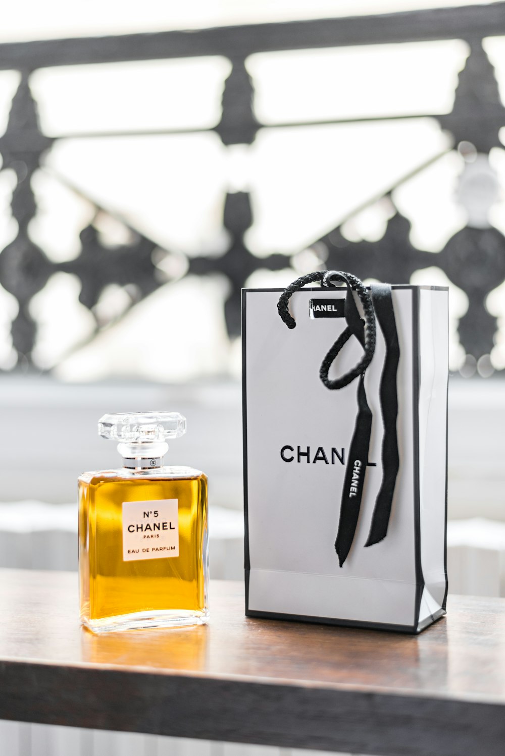 a bottle of chanel on a table next to a bag