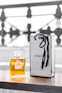 a bottle of chanel on a table next to a bag