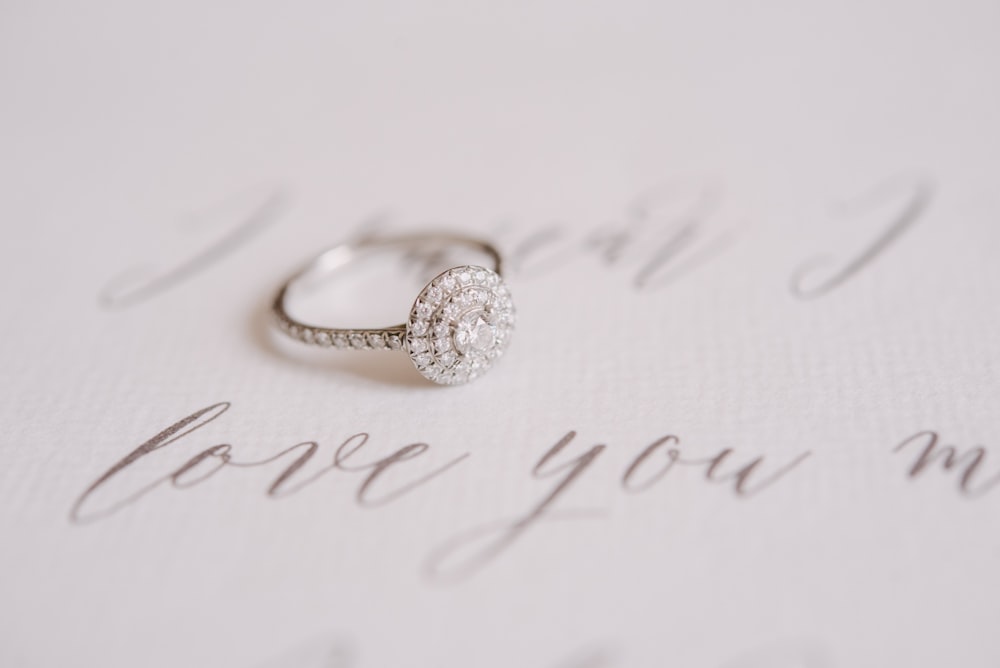 a wedding ring sitting on top of a piece of paper